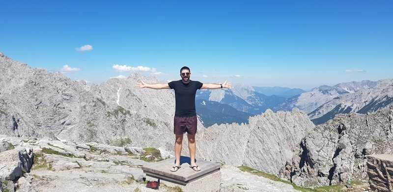 Darragh standing at the top of a mountain in Austria